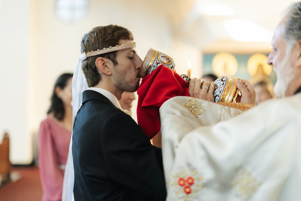 The groom drinks from the common cup