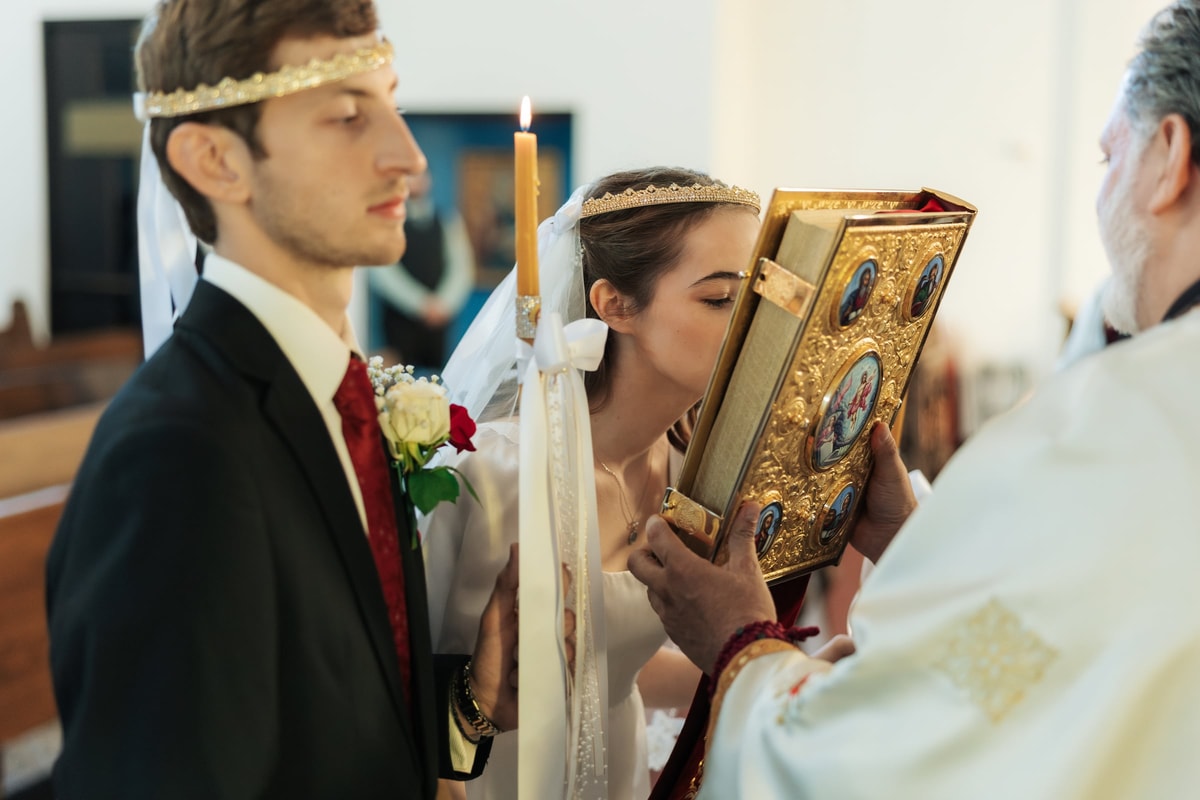 The bride kisses the Gospel book at the close of the service
