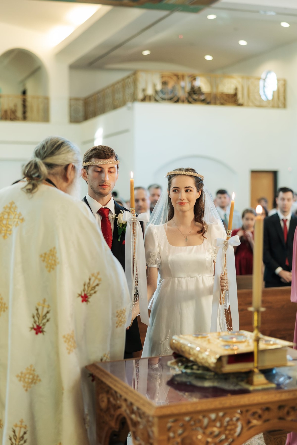 The bride and groom stand together before the tetrapod