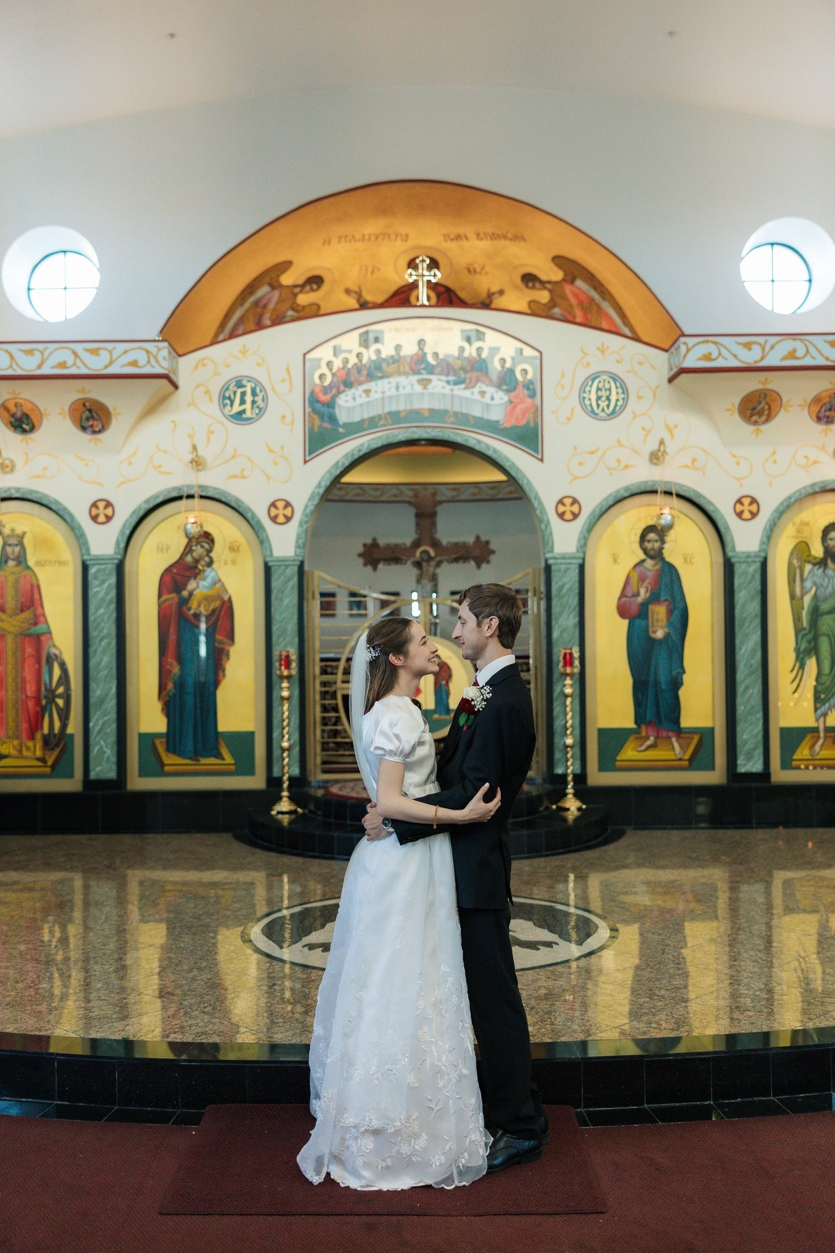 The bride and groom kiss inside the church