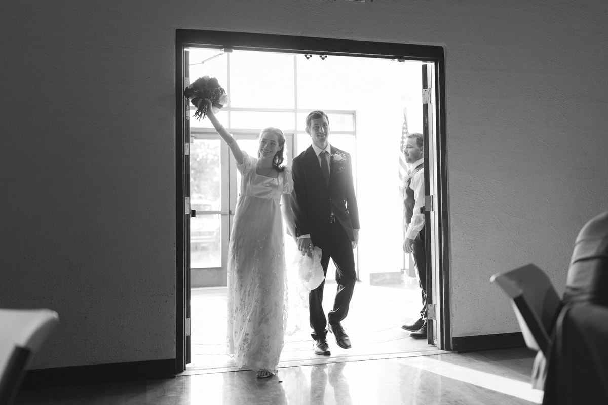 The bride and groom enter their wedding reception