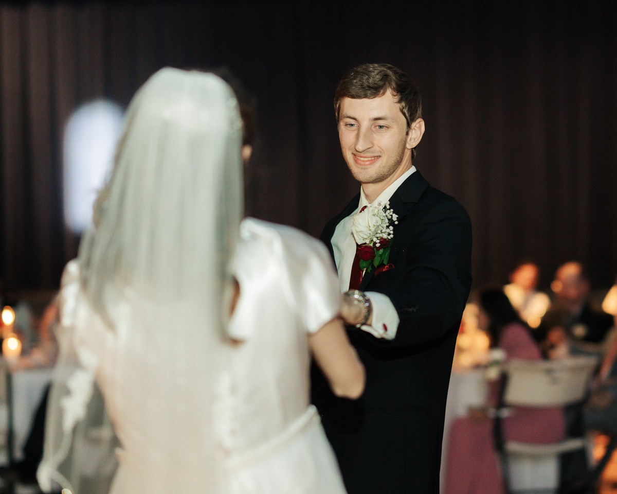The bride and groom dance together at their reception