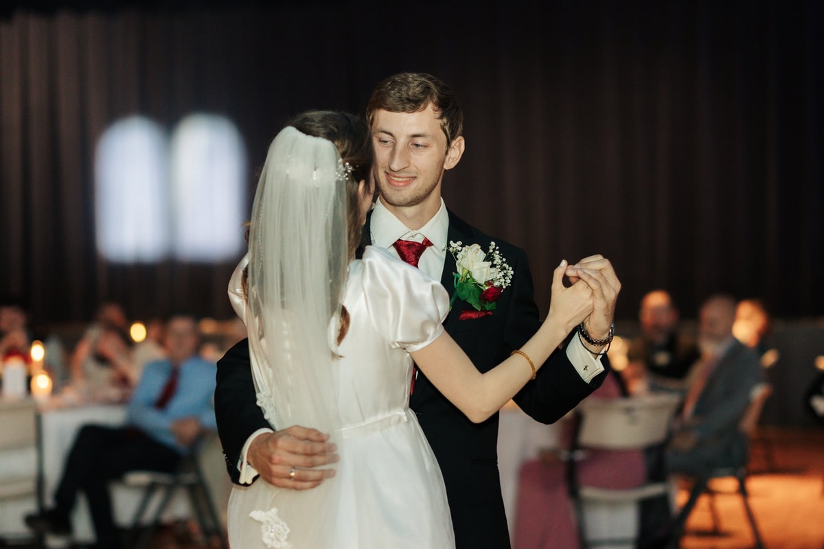The bride and groom dance together at their reception