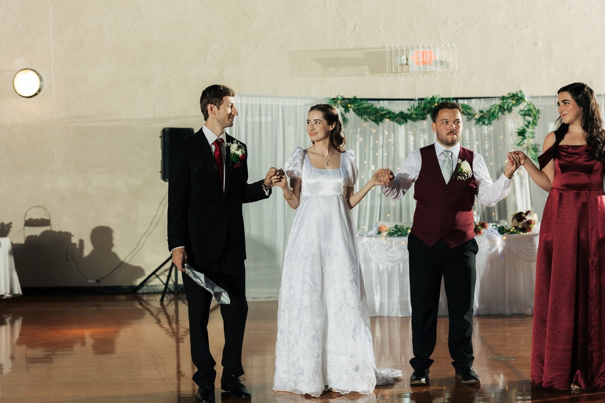The wedding party joins the bride and groom in a line dance