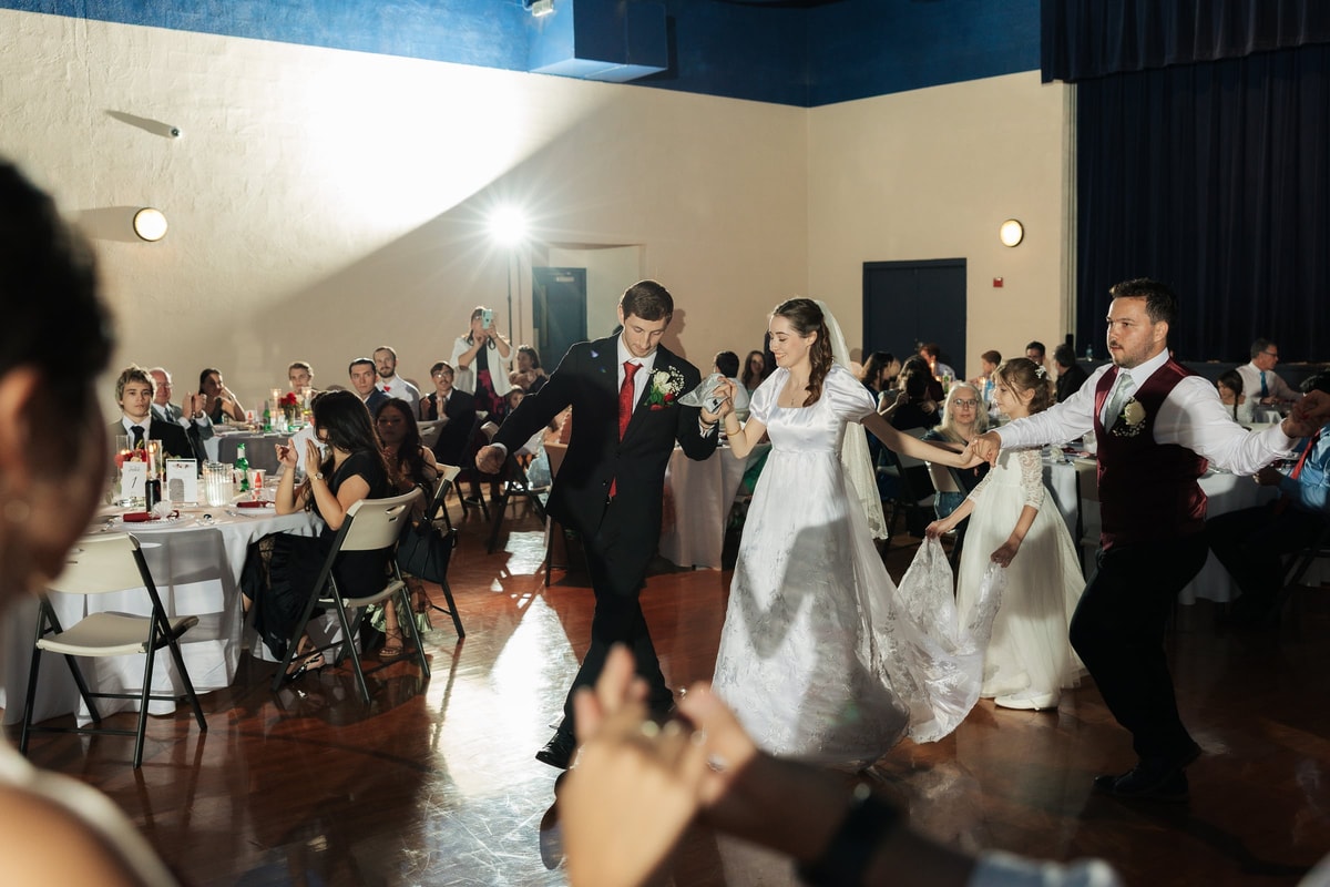 The wedding party joins the bride and groom in a line dance