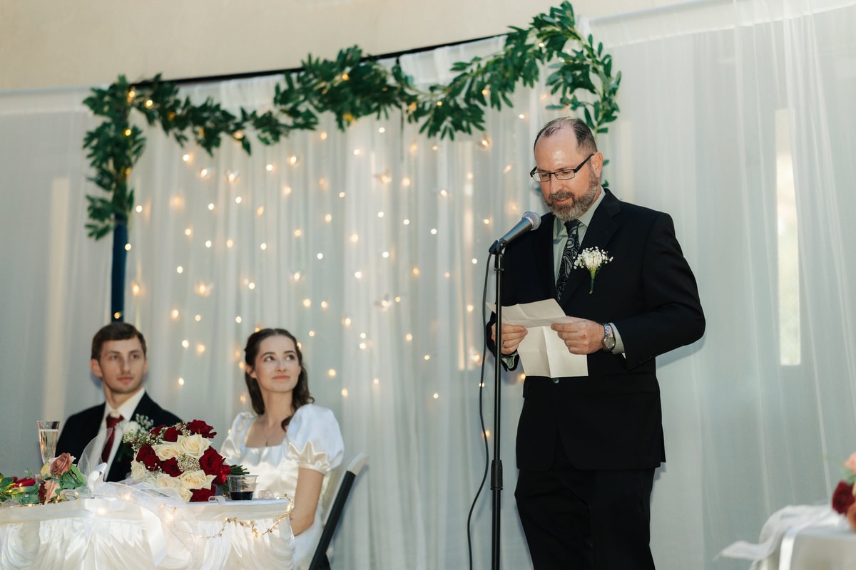 A guest gives a toast at the wedding reception