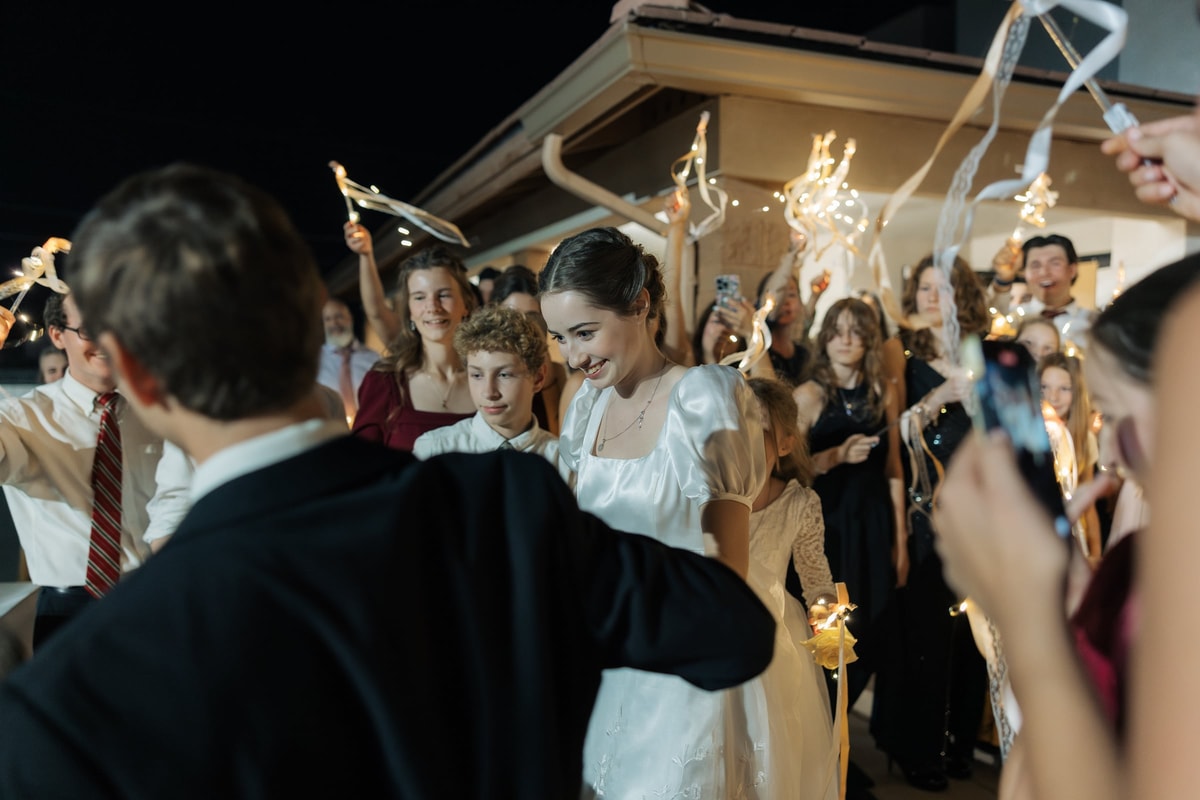 The bride and groom walk through a sparkler exit