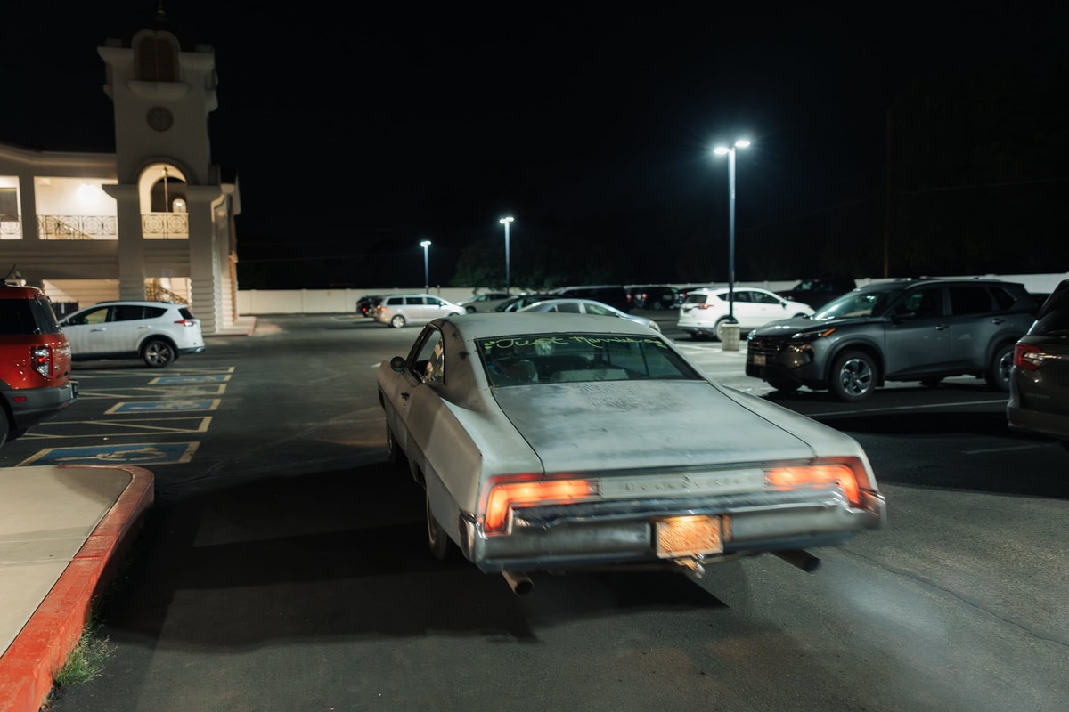 The couple's getaway car drives away at night